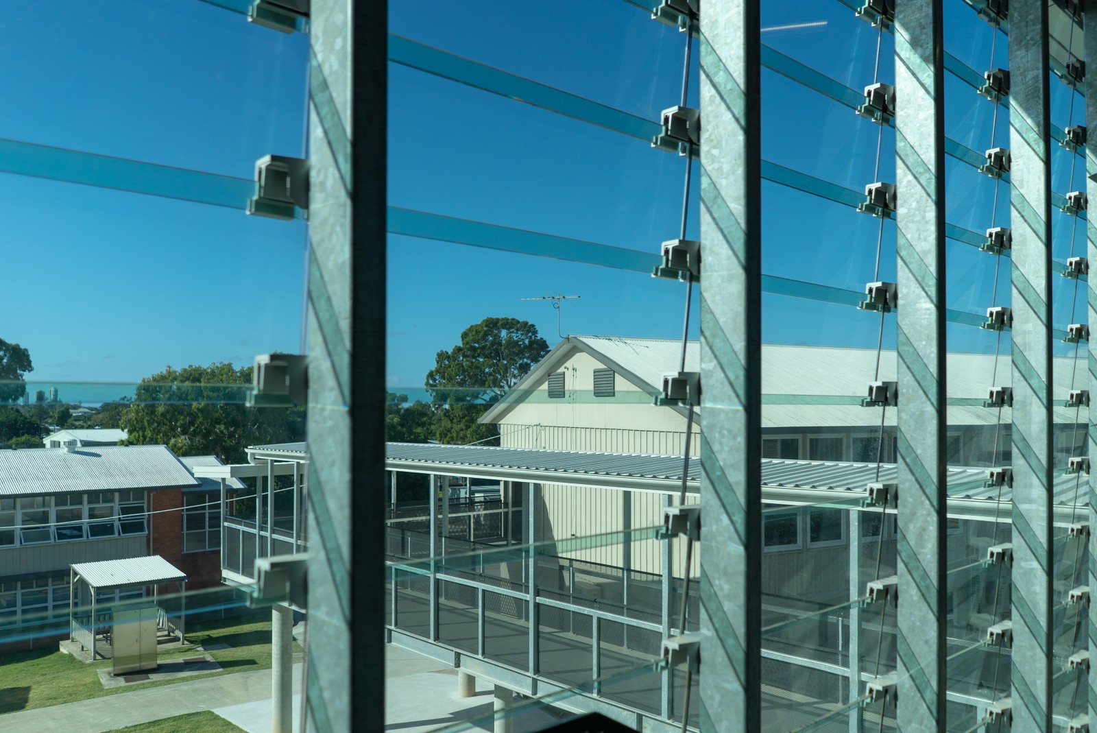 Fixed glass louvre bracket connections mounted to the supporting façade frame