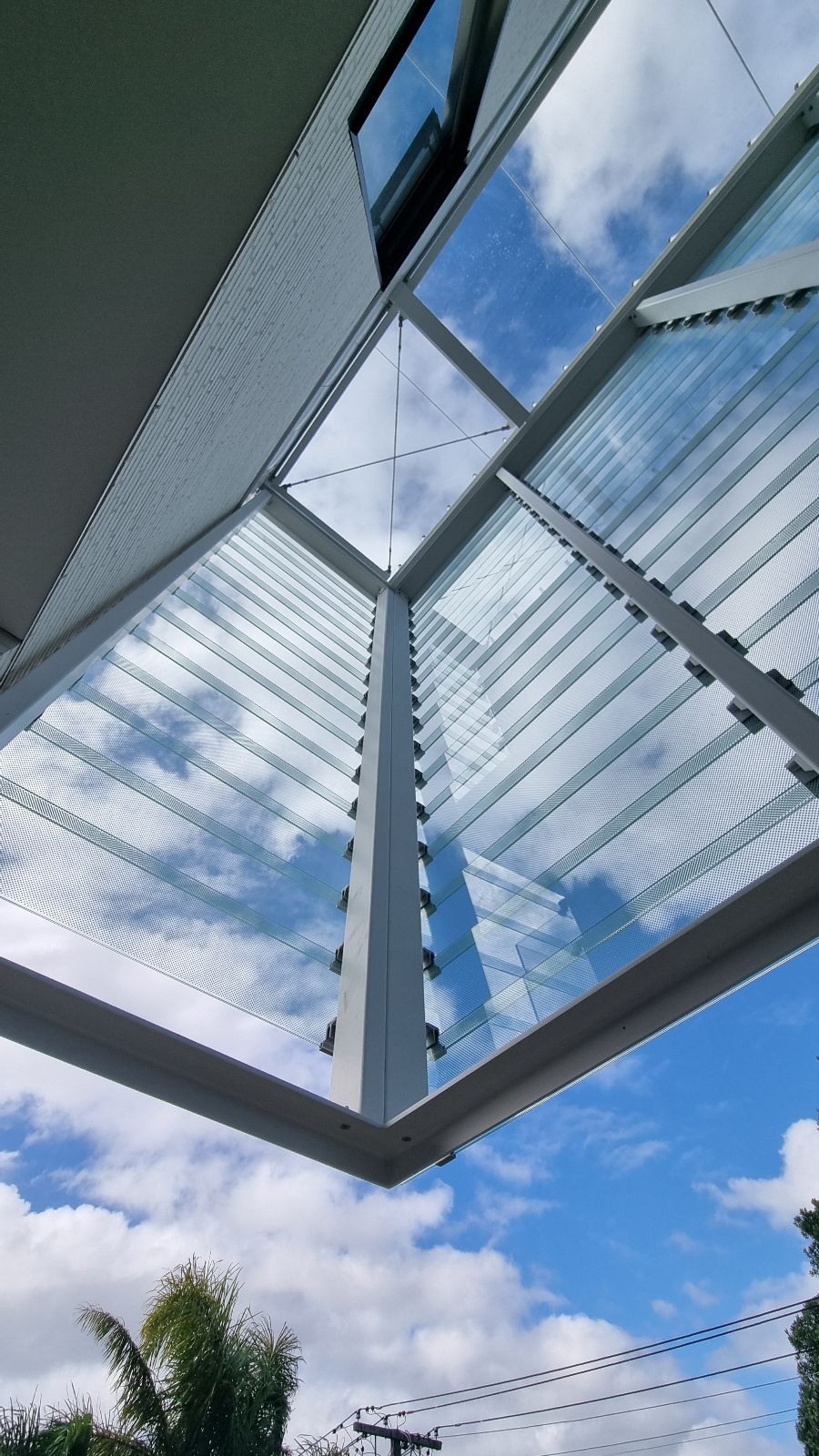 Fixed glass louvre weather screen viewed from below at a private residential project in Takapuna